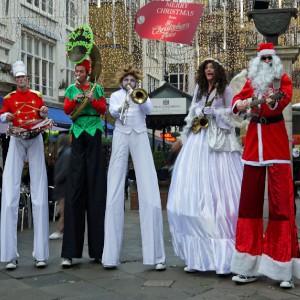 Christmas themed stilt walking band. Please quote toba4.