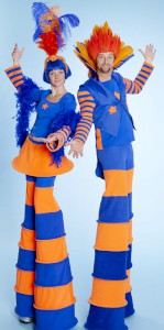 Blue and Orange carnival stilt walkers. Please quote trpe7.