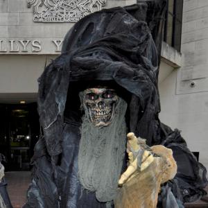 Stilt walking grim reaper