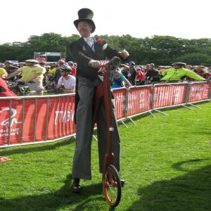 an stilt walking cyclist
